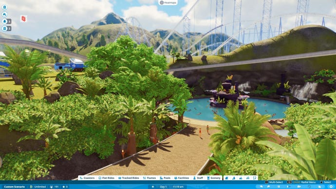 A path leading to a tropical themed pool, with a walkway suspended above it.